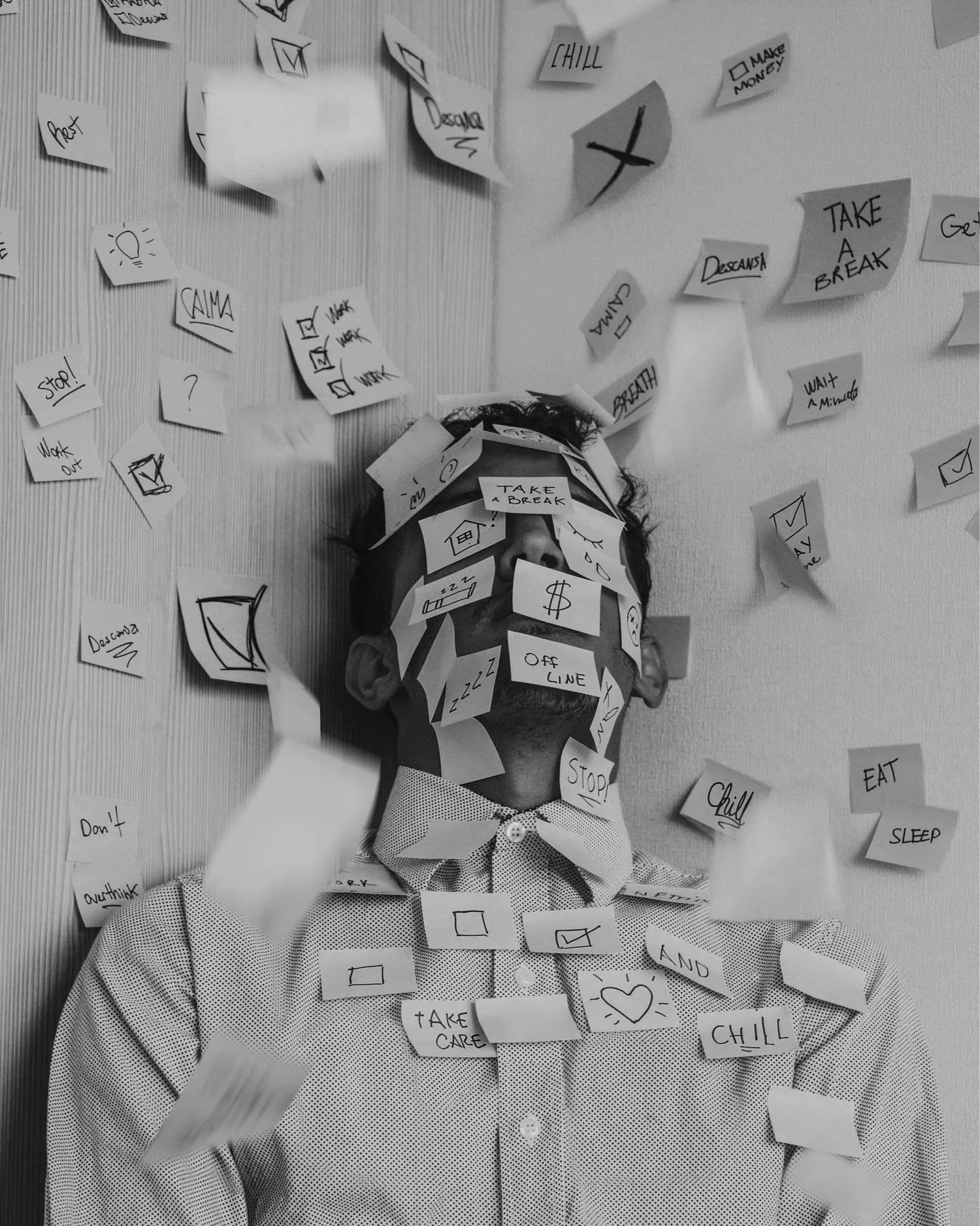 Black-and-white photo of a person whose face is covered in sticky notes