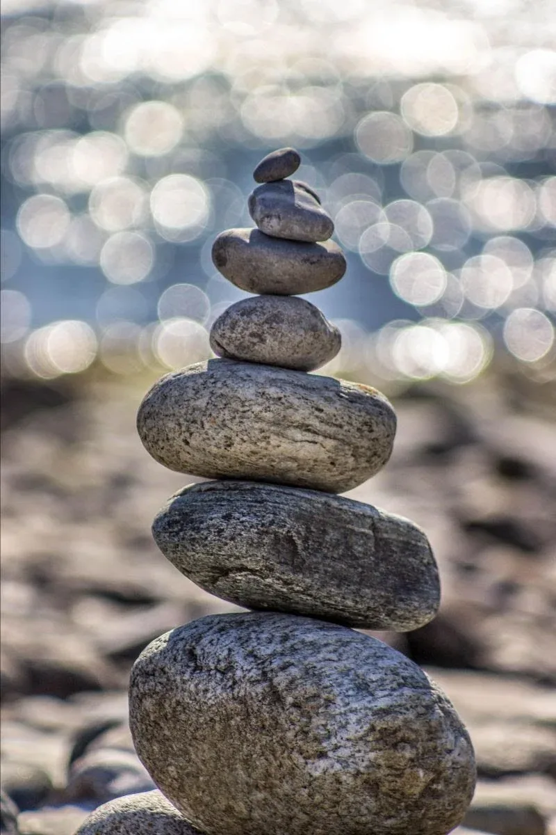 Stack of smooth balanced stones against a sparkling background