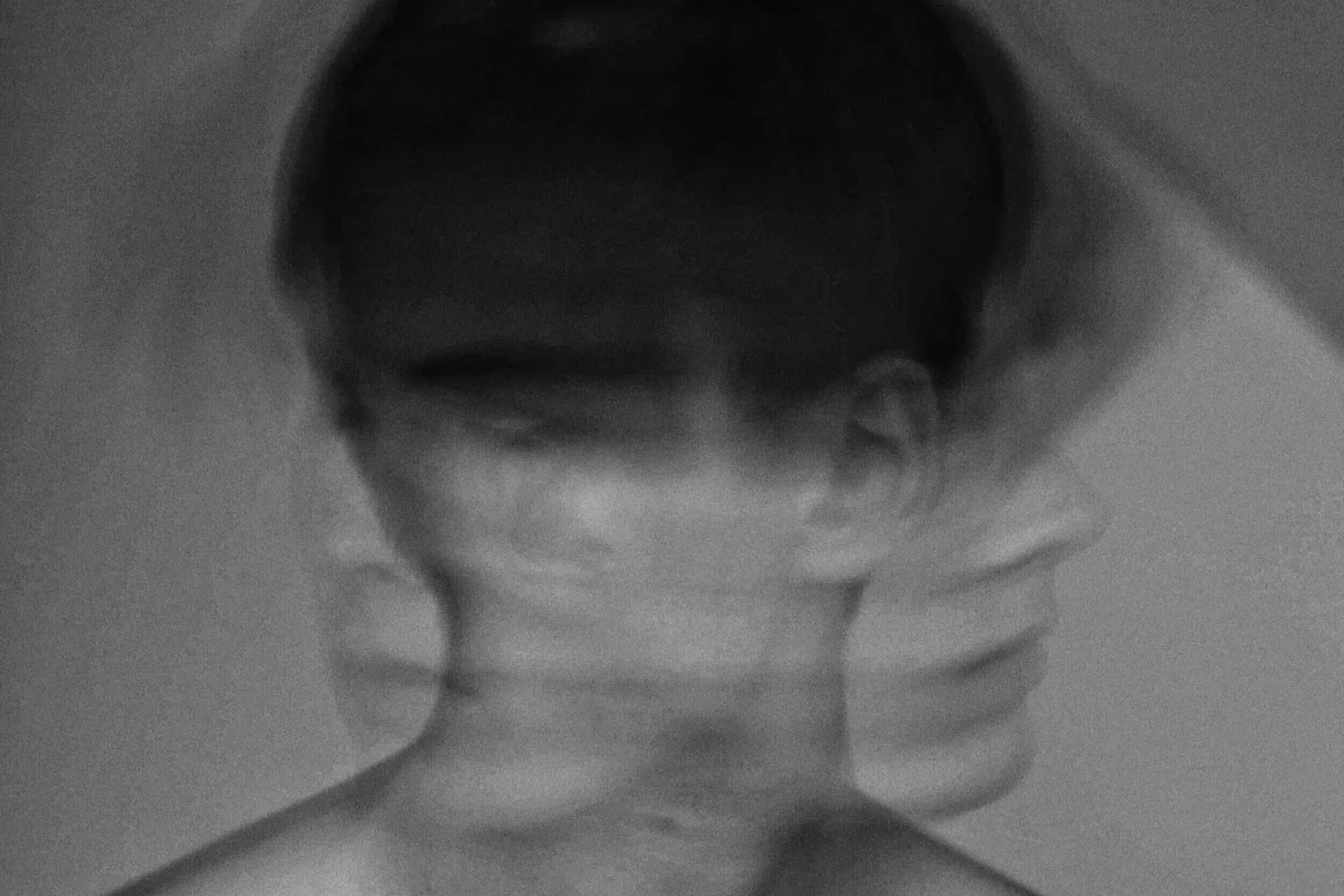 Black-and-white photo of a person’s face blurred by motion