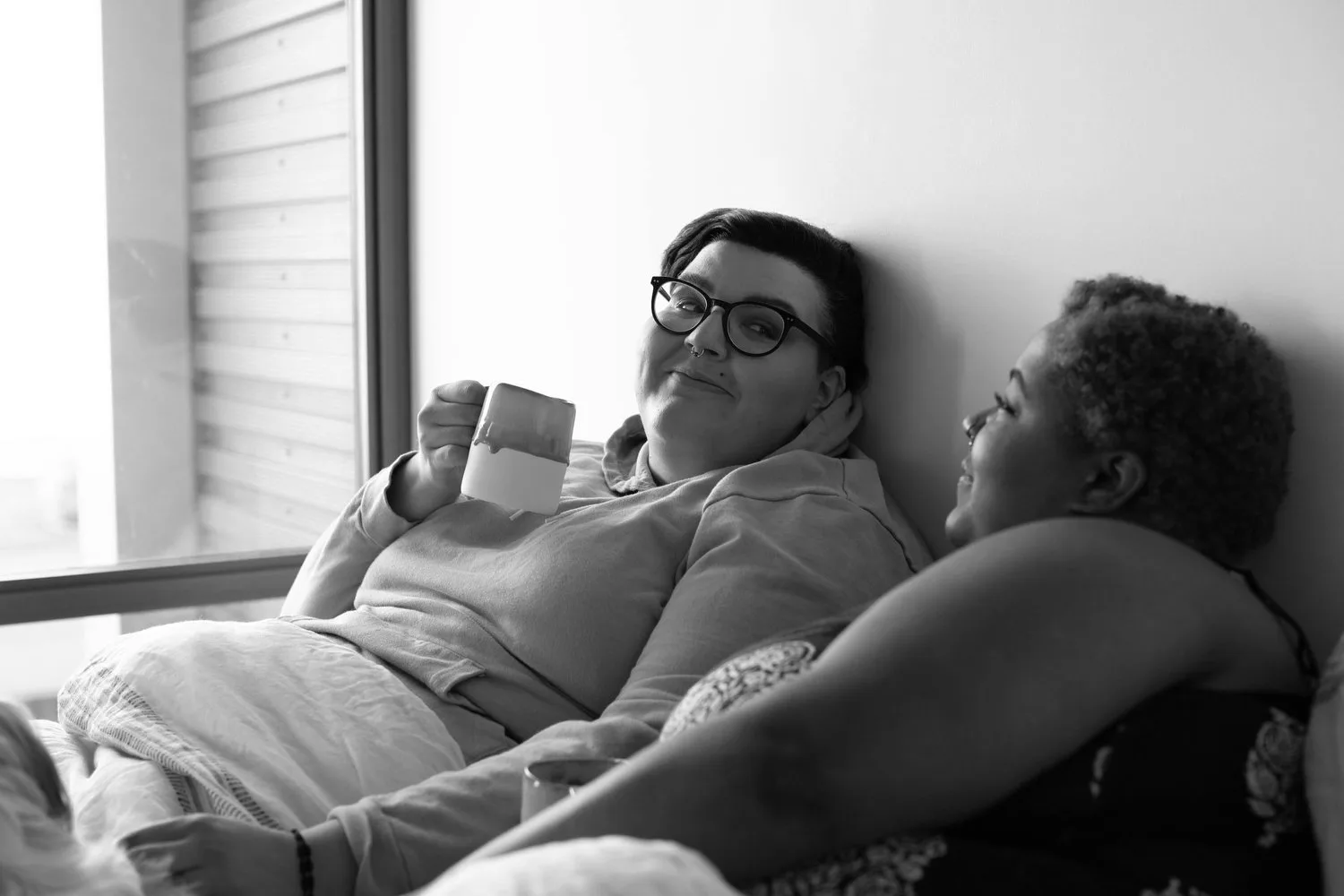 Black-and-white photo of an older couple resting on a sofa