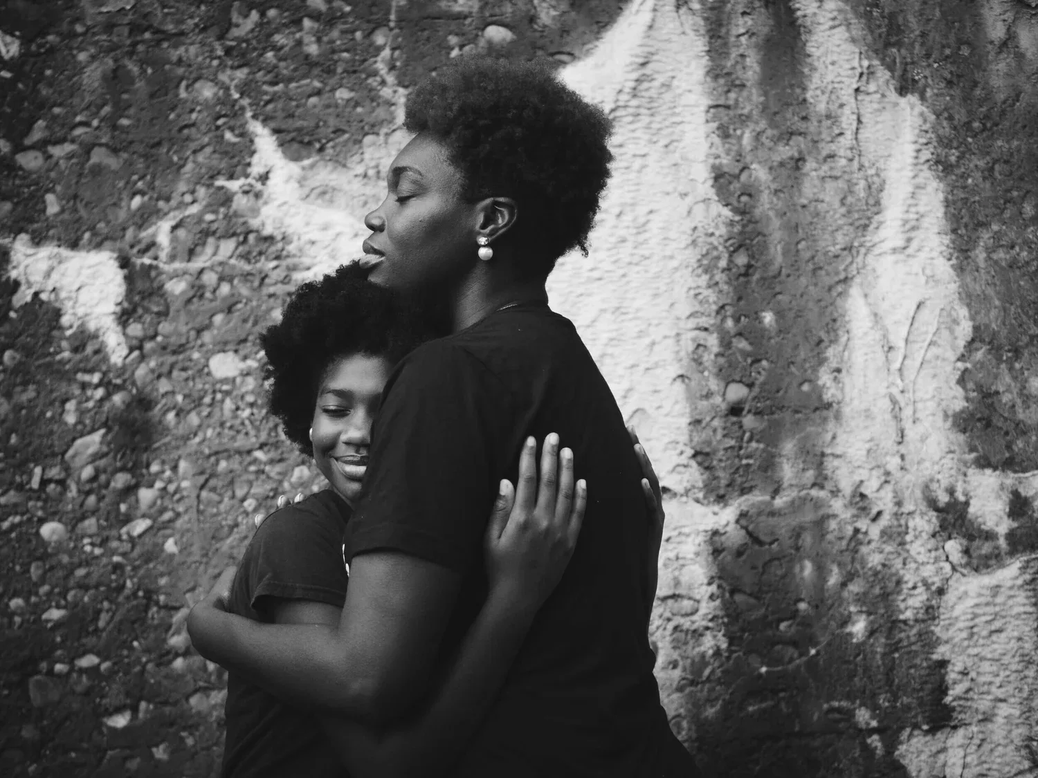 Black-and-white photo of two people embracing outdoors