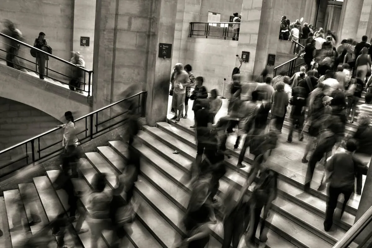 Blurred crowd rushing through a busy train station