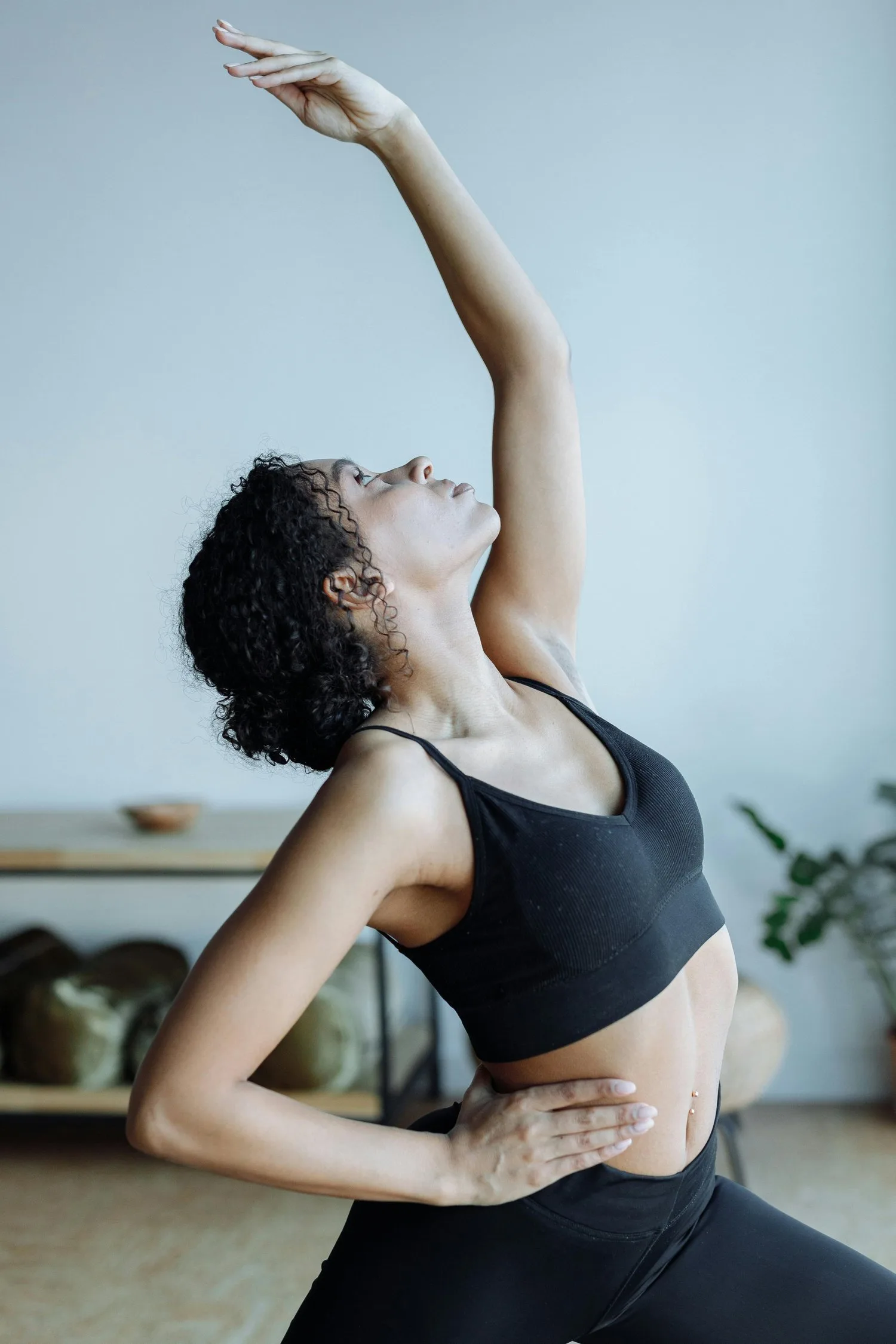 Woman in a side stretch reaching one arm overhead