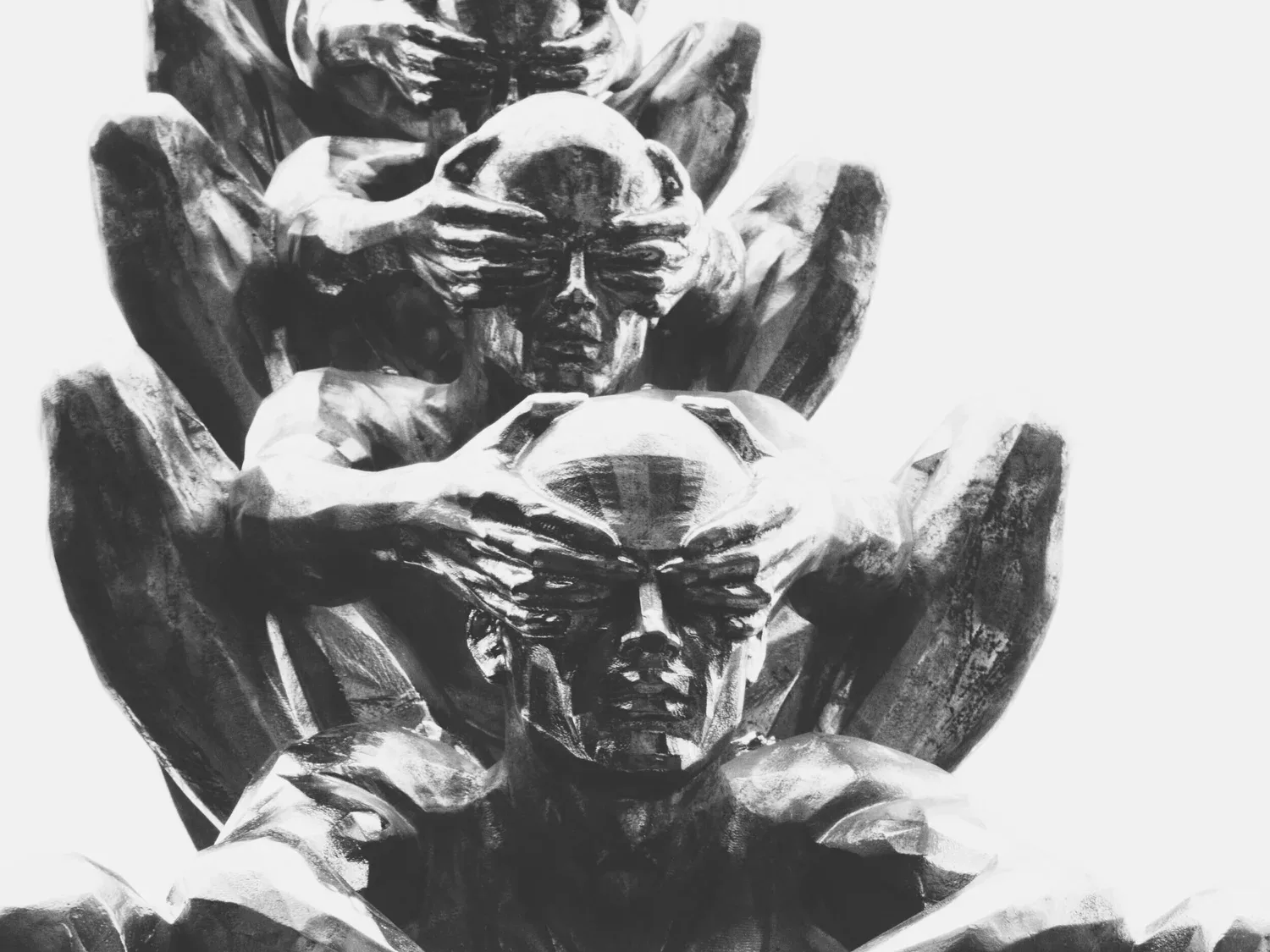Black-and-white photo of a carved statue of figures covering their eyes, ears, and mouth