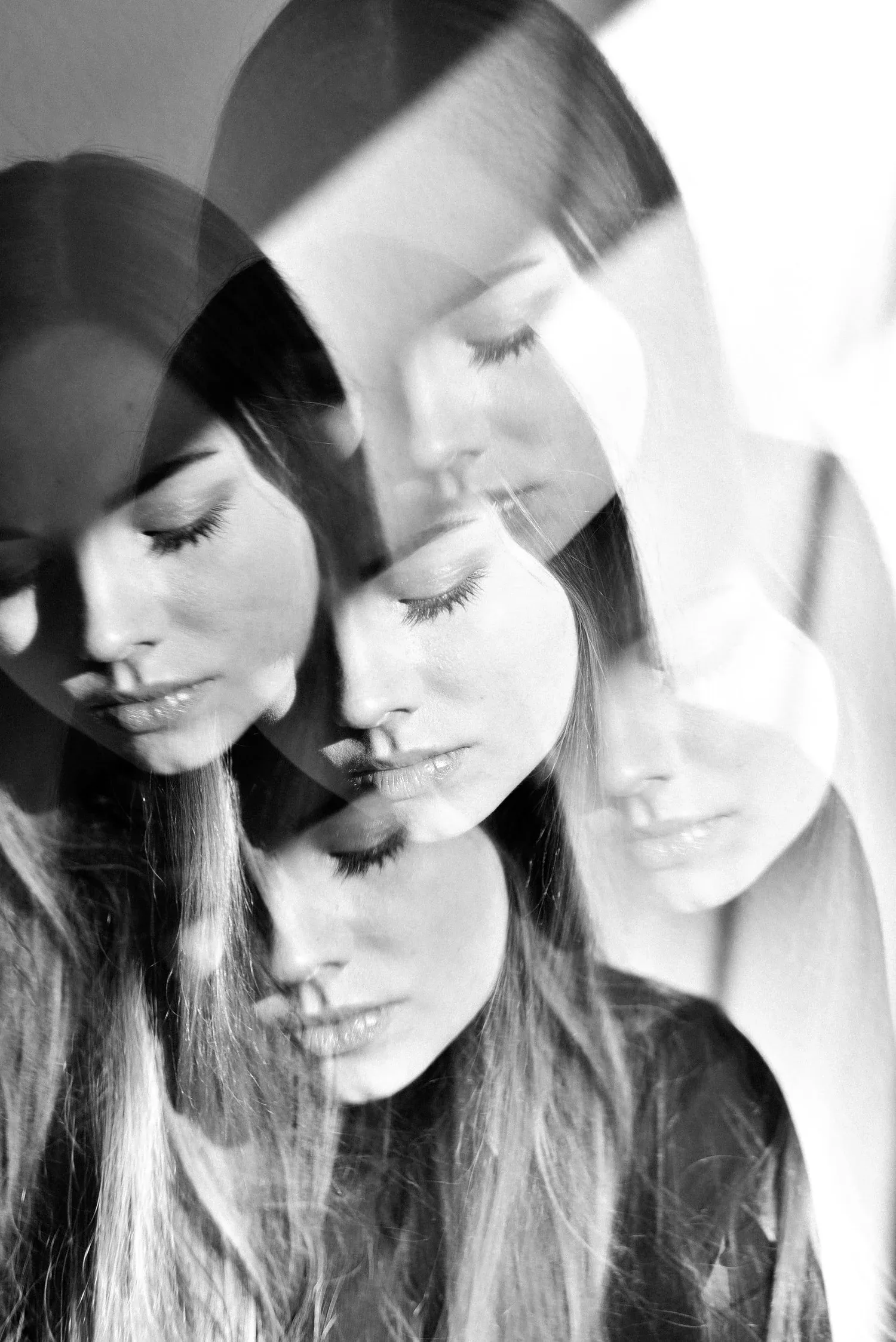 Black-and-white layered portrait of a woman’s face shown from several angles