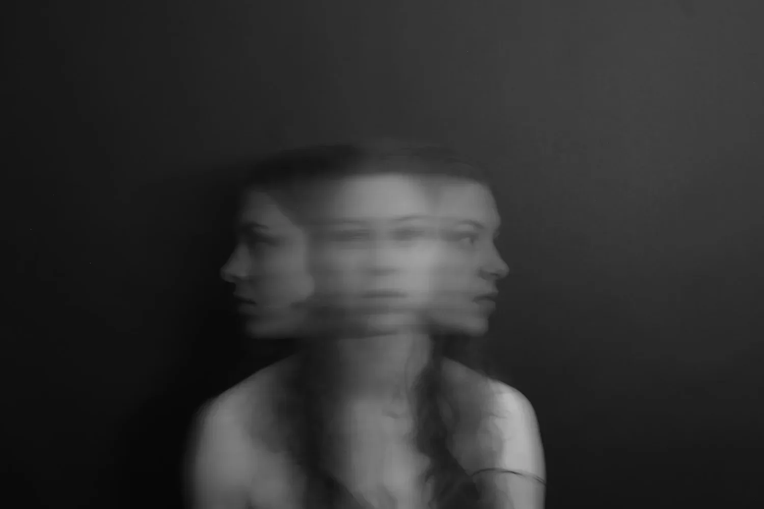 Blurred, double-exposed portrait of a person turning their head