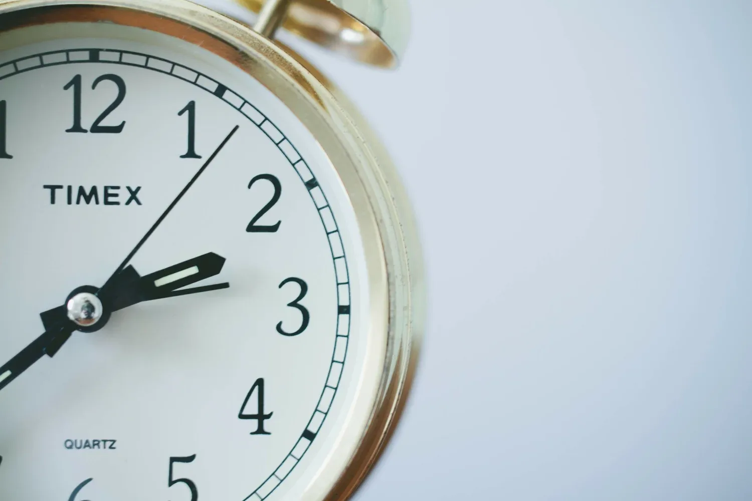 Close-up of an analog alarm clock face