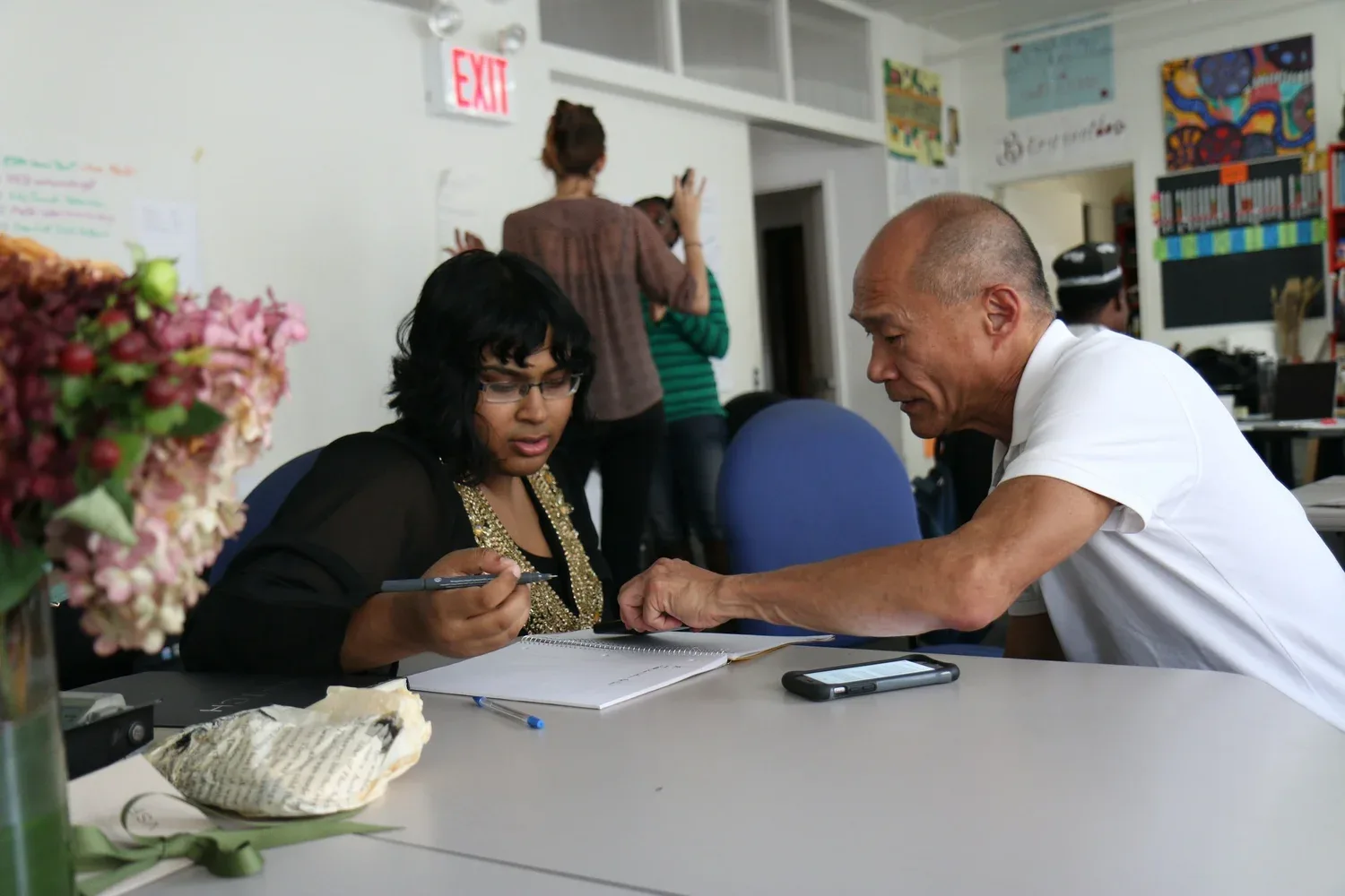 Small group working together around a table in a bright office