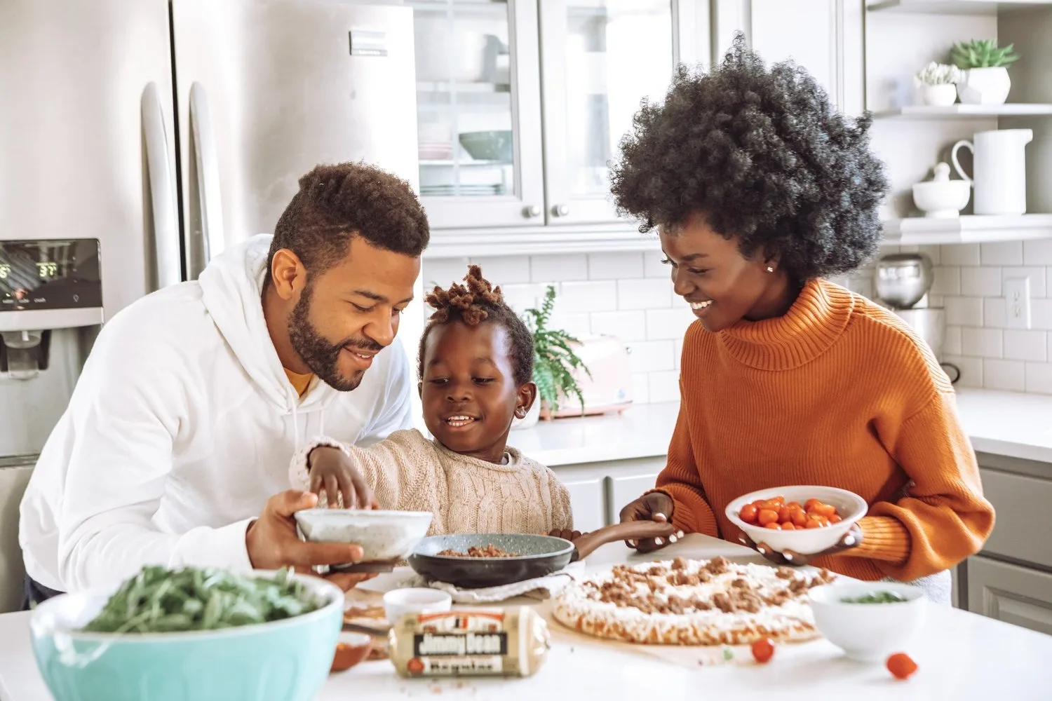 Parents and young child sharing a meal at a kitchen table