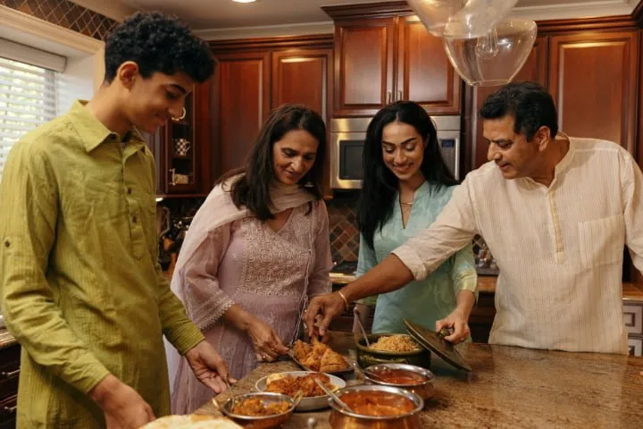 South Asian family sharing a festive meal together around a kitchen island