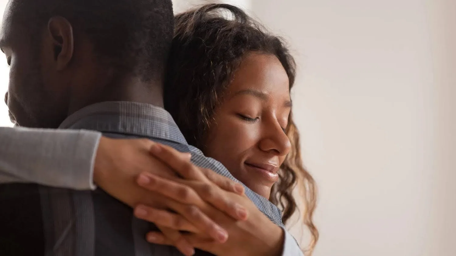 Smiling woman embracing a man in a warm hug
