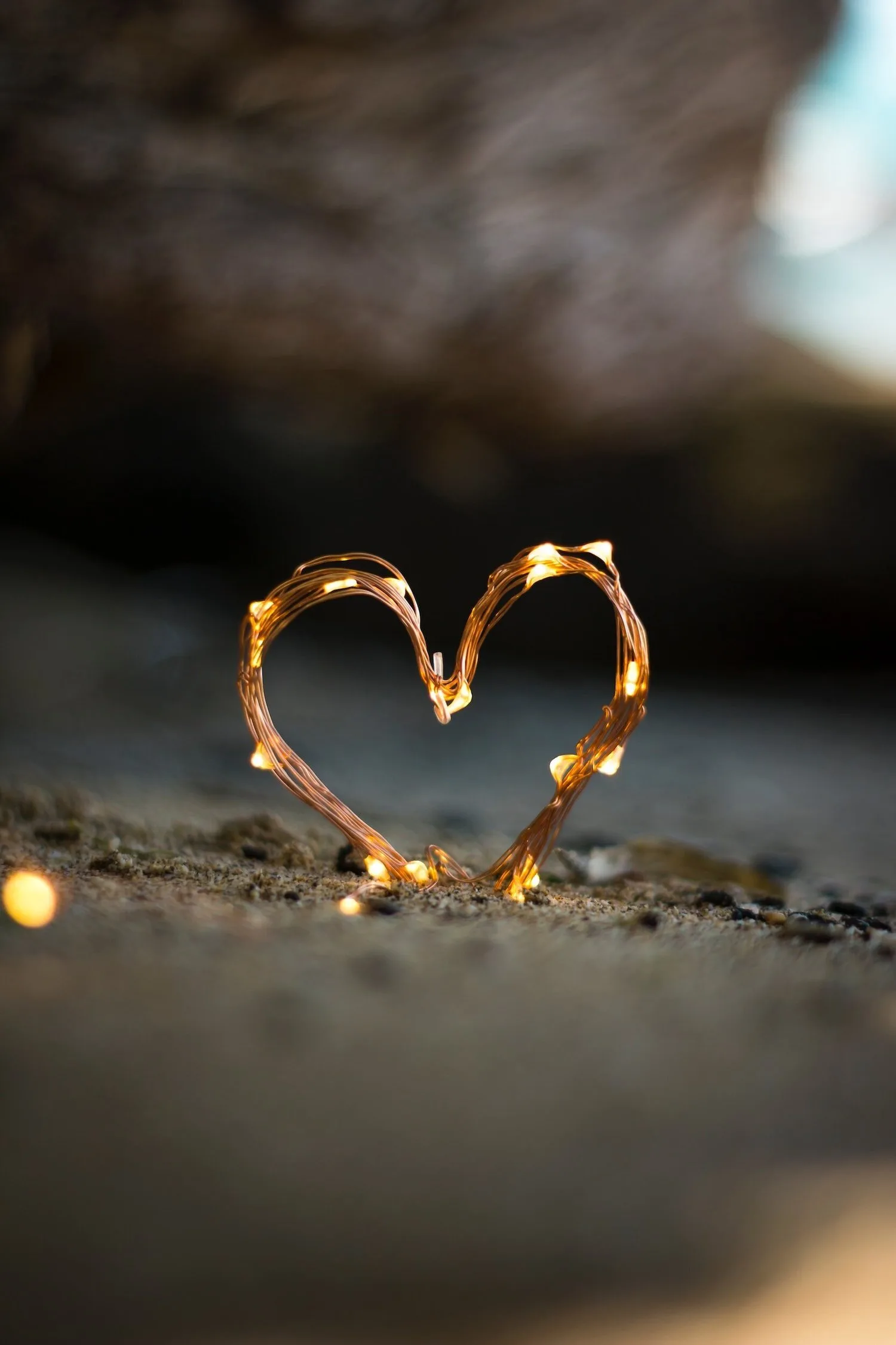 Small heart-shaped string of lights glowing in the dark
