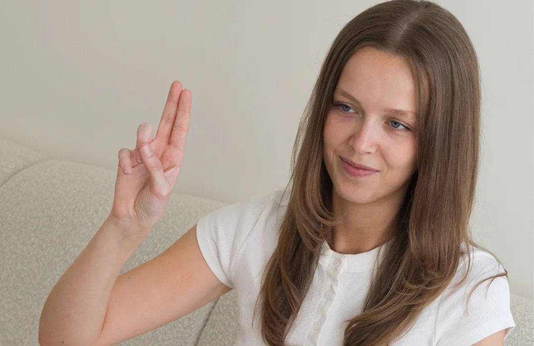 Woman following two raised fingers with her eyes, as in an EMDR session