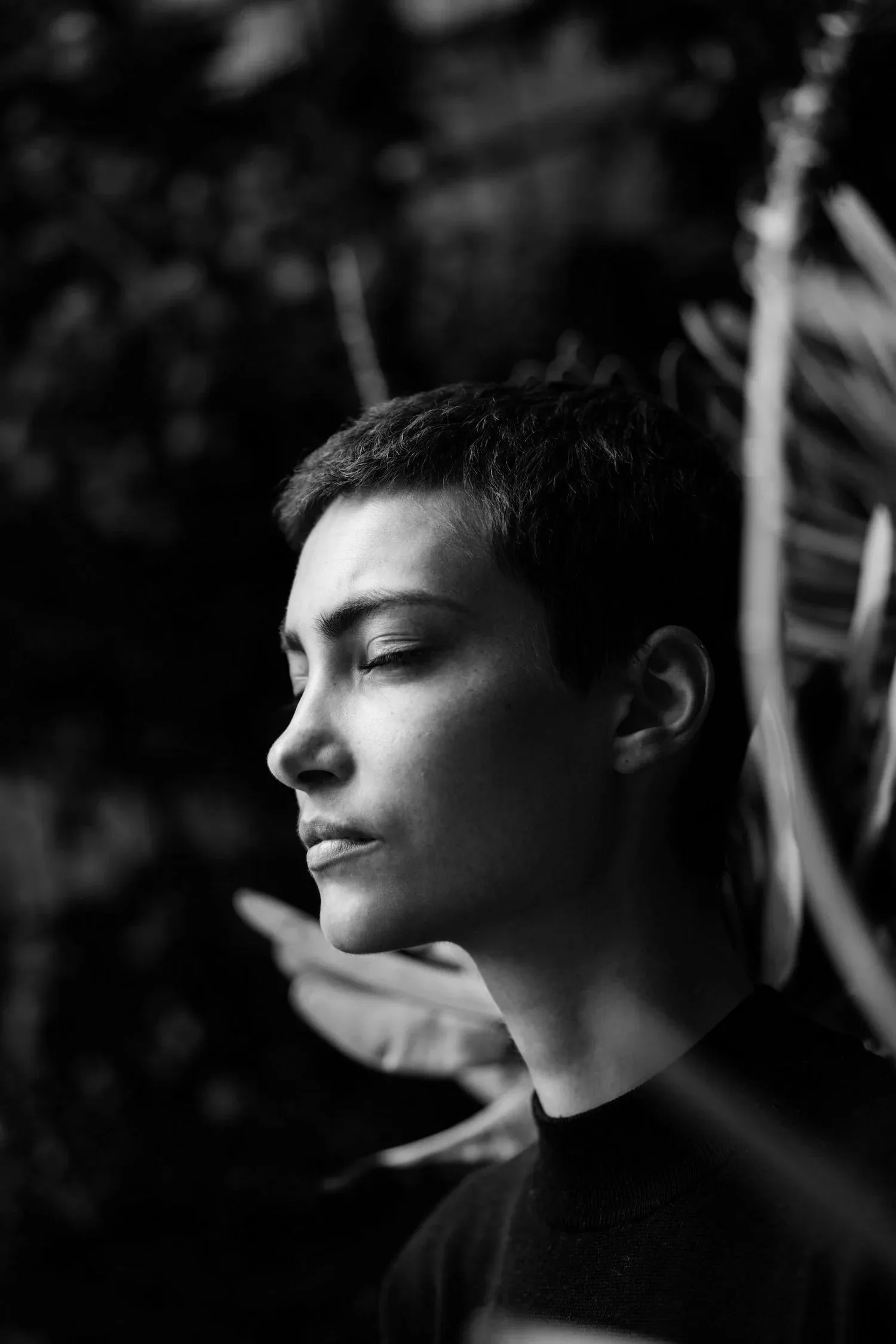Black-and-white portrait of a young person in profile