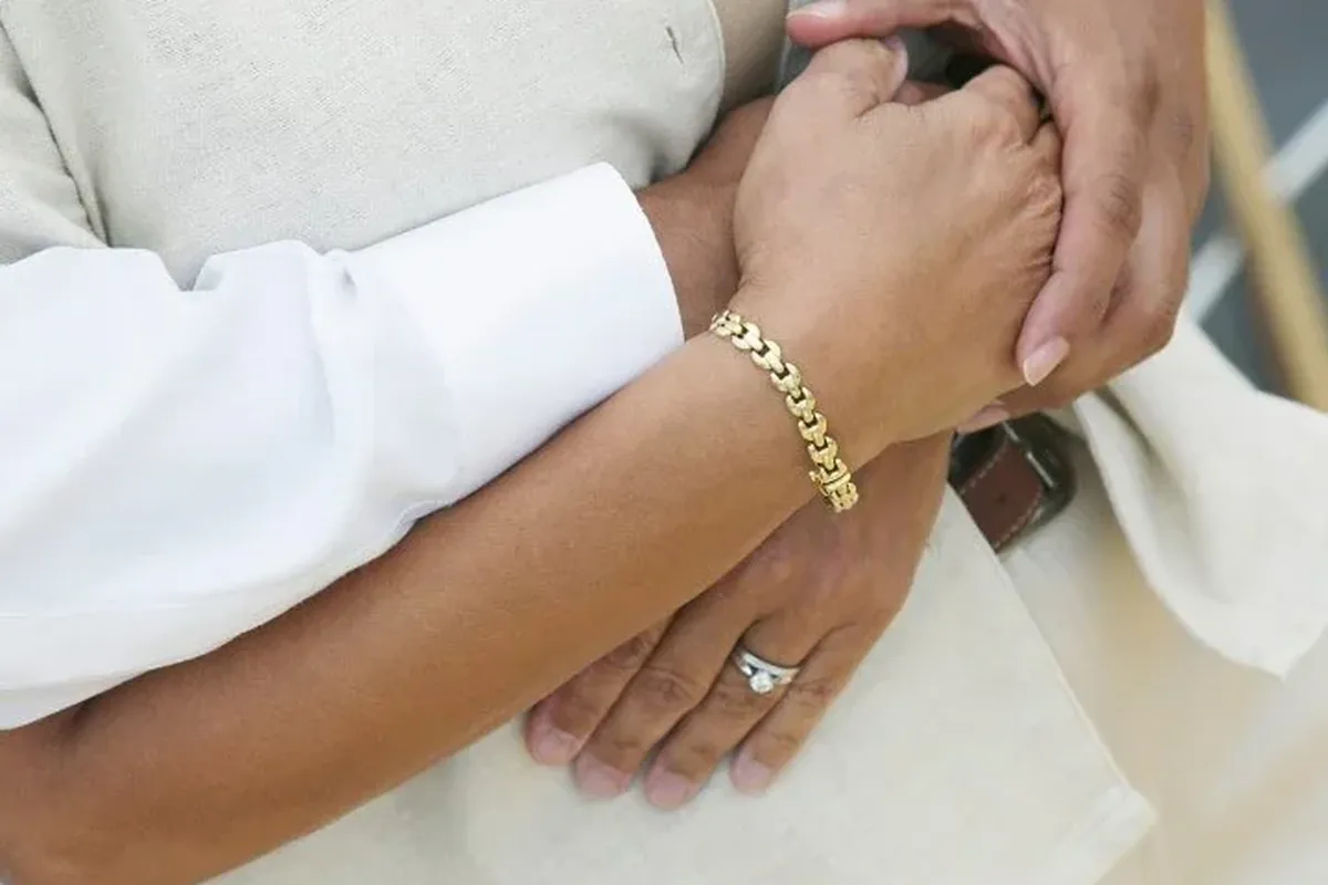 A couple holding hands in a close embrace