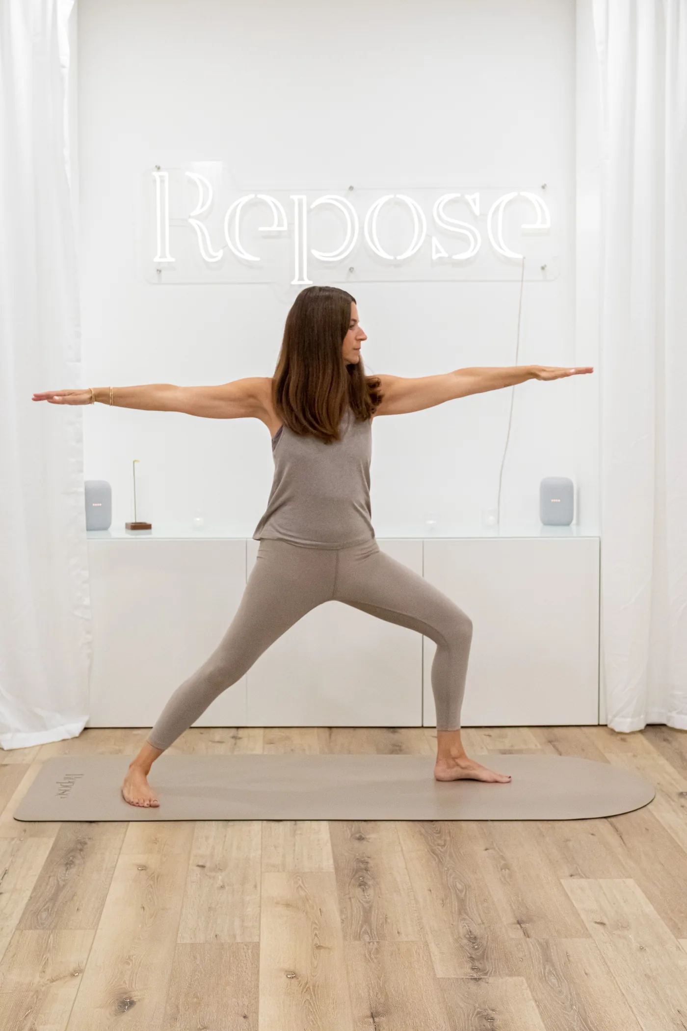 A person moving through a standing yoga posture