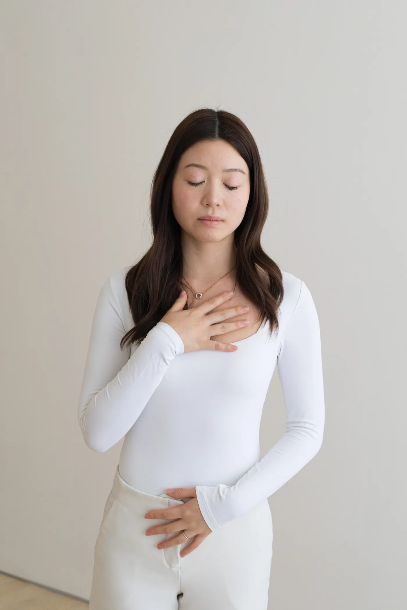 A person breathing slowly with a hand on the chest