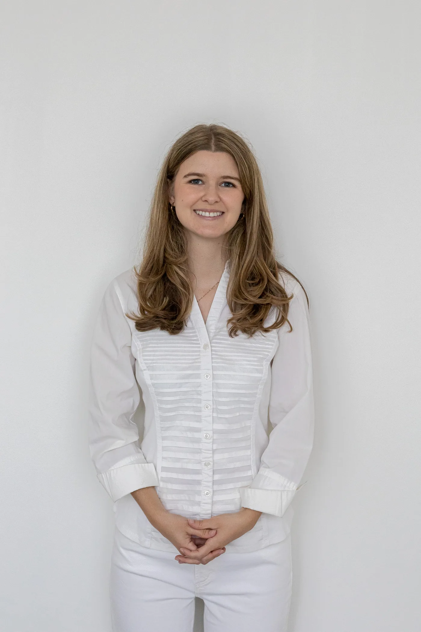 A person standing calmly in a bright room